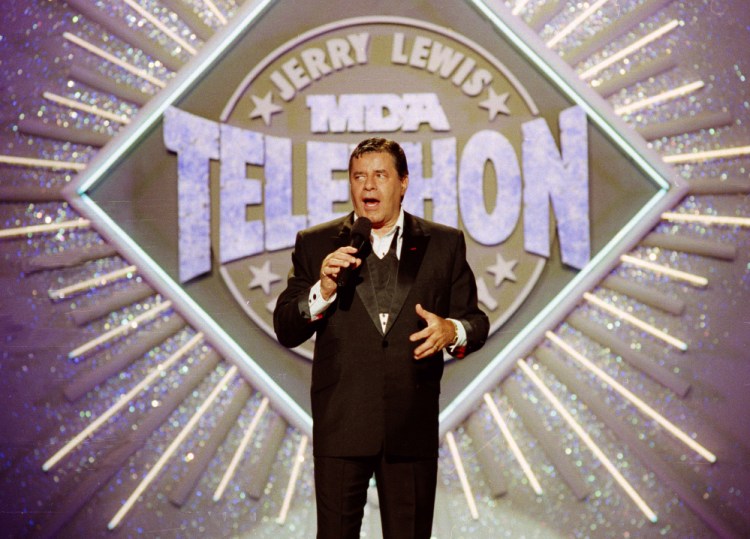 Entertainer Jerry Lewis makes his opening remarks at the 25th anniversary of the Jerry Lewis MDA Labor Day Telethon fundraiser in Los Angeles in 1990. Lewis, the comedian whose fundraising telethons became as famous as his hit movies, has died at 91.