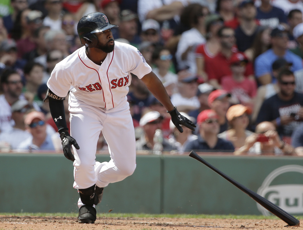 Jackie Bradley Jr. watches the flight of his two-run triple in the second inning of the Red Sox' 5-1 win over the Yankees on Sunday in Boston.