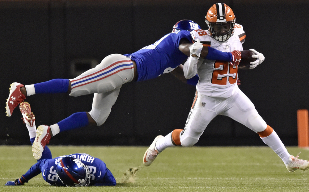 Cleveland running back Duke Johnson tries to break a tackle by Giants cornerback Dominique Rodgers-Cromartie in the first half of a preseason game Monday in Cleveland. Johnson rushed for 28 yards in the Browns' 10-6 win.