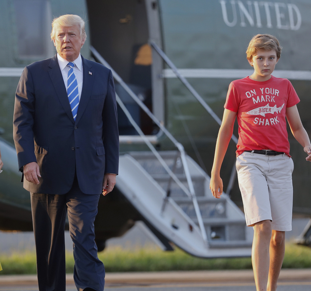 President Trump and son Barron walk across the tarmac to board Air Force One at Morristown Municipal Airport in New Jersey on Sunday for the return flight to the Washington area.