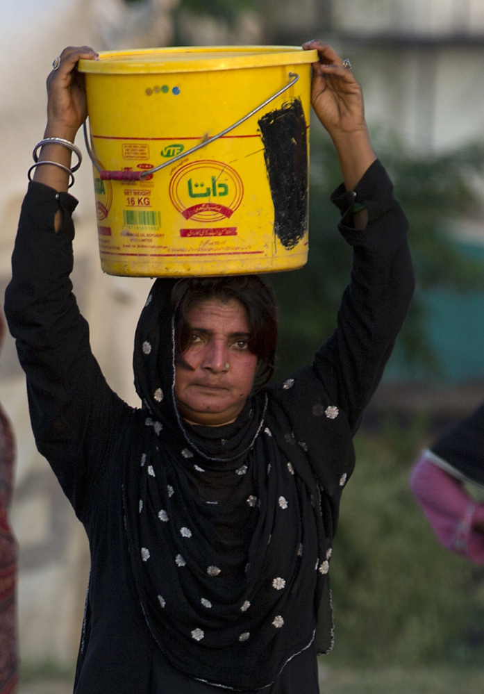 Water that a woman carries from a well in Rawalpindi, Pakistan, could present long-term danger from arsenic, a study suggests.