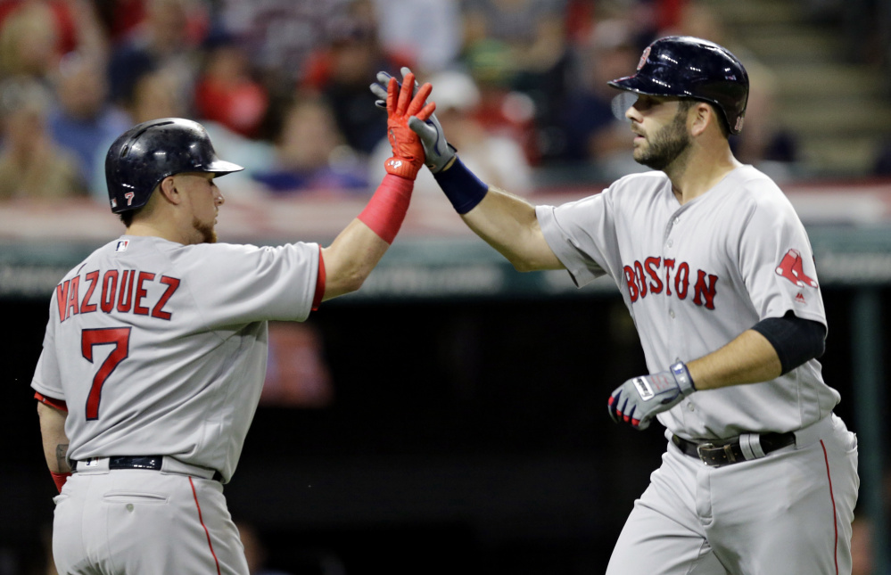 Boston's Mitch Moreland, right, is congratulated by Christian Vazquez after hitting a solo home run off Cleveland starter Corey Kluber and giving the Red Sox a 1-0 lead in the fifth inning.