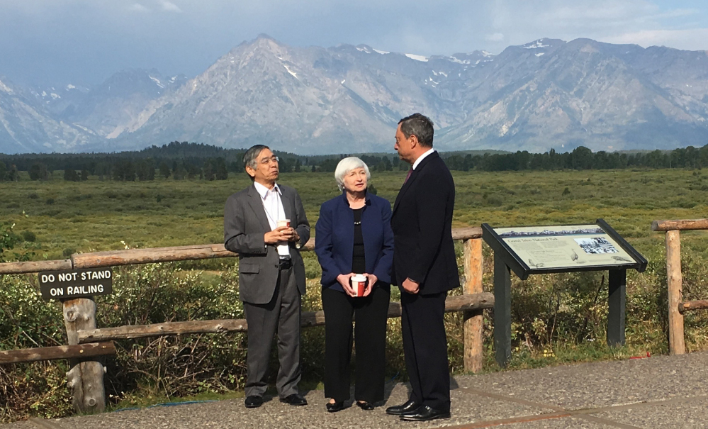 Federal Reserve Chair Janet Yellen, center, confers with Mario Draghi, right, head of the European Central Bank, and Haruhiko Kuroda, head of the Bank of Japan, during a break at an annual conference Friday at Jackson Hole, Wyo.