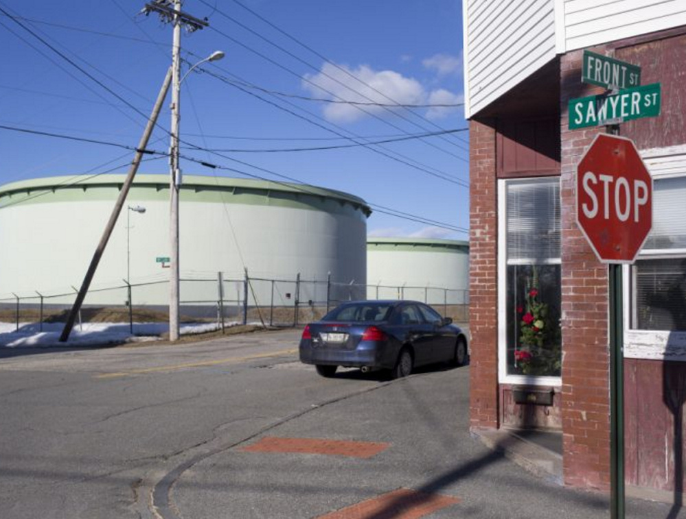 At right, a Portland Pipe Line Corp. tank in South Portland. A judge said Friday that the firm's "only alternative to shutting down its pipelines is to attempt to use them in a different way." The city's motion to have the case dismissed was denied Friday.
