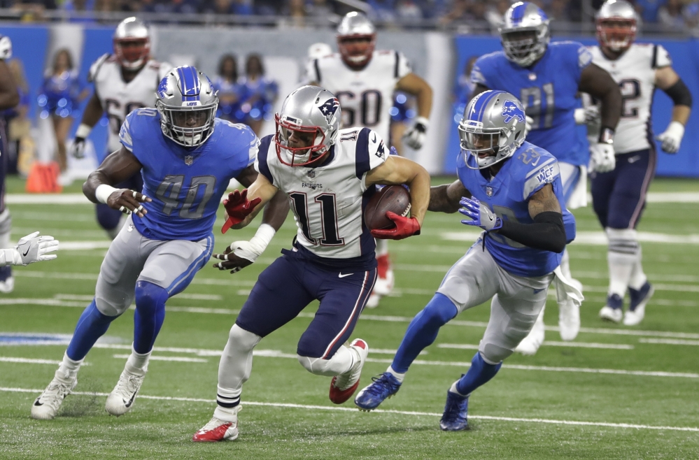 Patriots wide receiver Julian Edelman breaks downfield as Lions linebacker Jarrad Davis, left, and cornerback Darius Slay give chase during a preseason game Friday night. Edelman caught three passes on New England's opening touchdown drive but left the game with a knee injury.