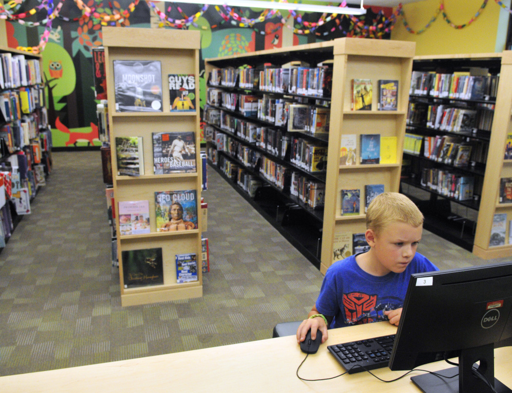 Wesley Jordan, 10, plays Minecraft on a computer in the children's area of the Lithgow Public Library on Aug. 18 in Augusta.