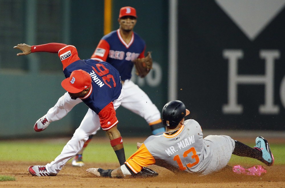 Red Sox second baseman Eduardo Nunez tries to avoid Baltimore's Manny Machado, who was attempting to steal second base. Nunez injured his left wrist and thumb when he landed awkwardly and had to leave the game, which the Orioles won, 16-3.