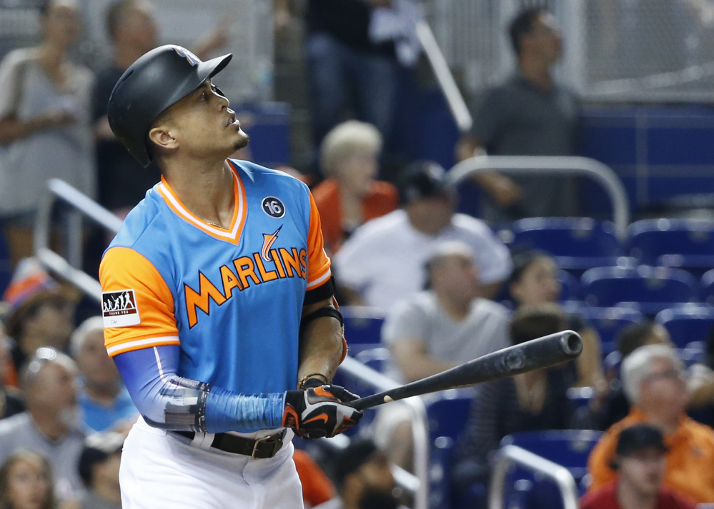 Giancarlo Stanton of the Marlins watches his two-run home run during the first inning Friday night against San Diego. Stanton added another homer in the third, his 49th of the season.