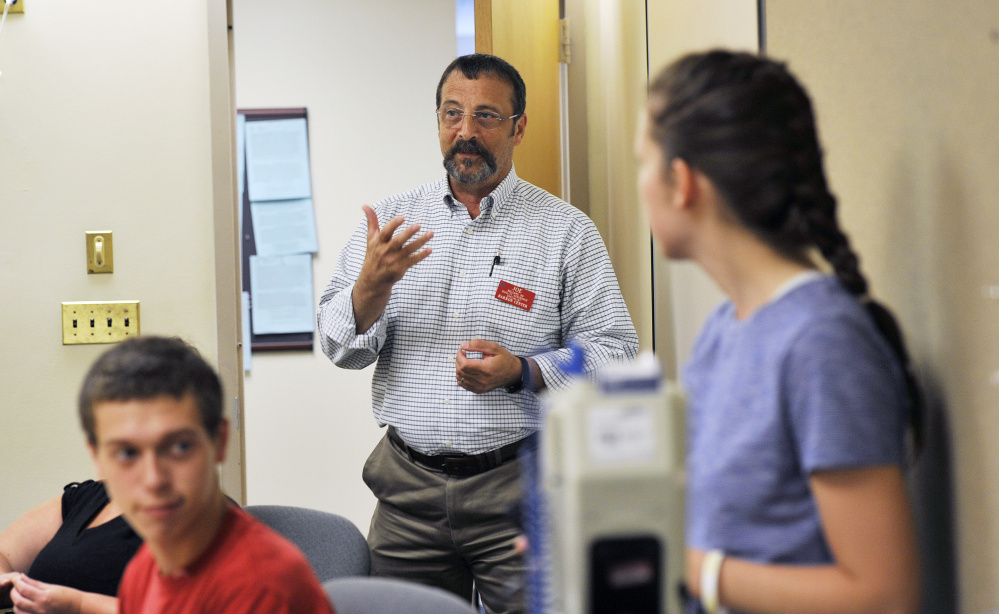 Joe Balzano, a registered nurse, talks with students during training for certified nursing assistants at the Barron Center in Portland last month. Starting pay for CNAs is $12.92 an hour, according to city officials.