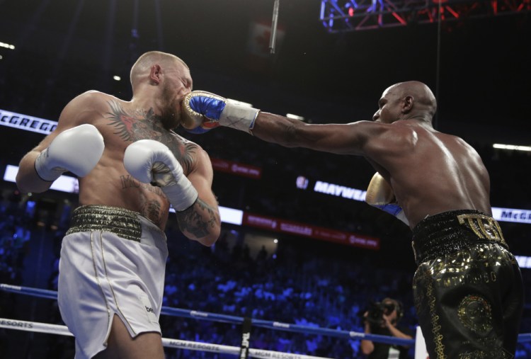 Floyd Mayweather Jr. jabs Conor McGregor. McGregor, in his first professional boxing match, made it into the 10th round before the referee stopped the fight.