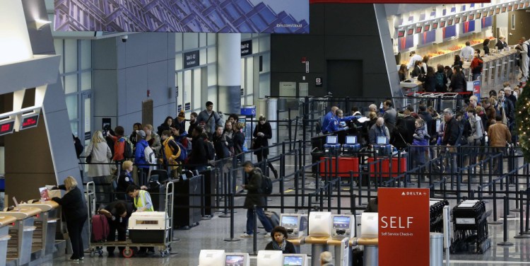 Passengers line up at the security checkpoint in terminal A at Logan International Airport in Boston.