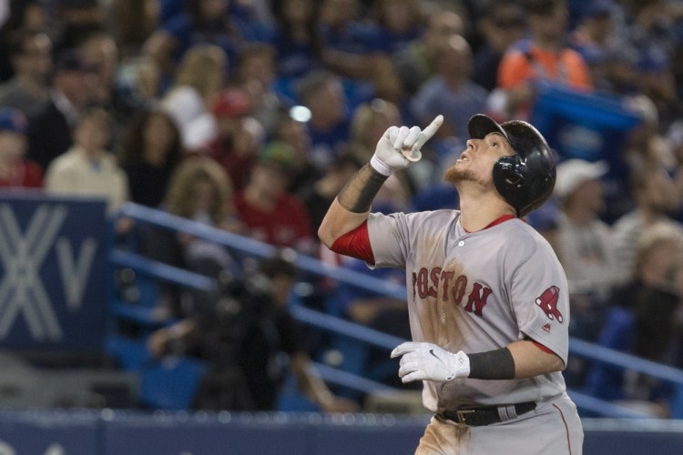 Boston catcher Christian Vazquez gestures skyward after hitting a two-run home run in the pivotal seventh inning Monday night in Toronto.