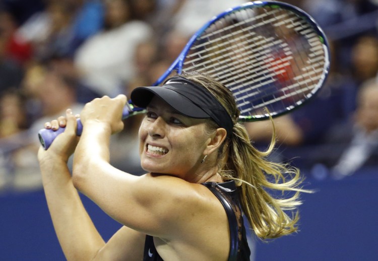 Maria Sharapova follows through on a shot Monday night during her three-set victory against second-seeded Simona Halep in the opening round of the U.S. Open.