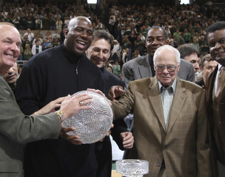 Thirty years after defeating the Larry Bird-led Indiana State team for the 1979 NCAA basketball championship, Magic Johnson, second left, and his teammates reunited with Coach Jud Heathcote at Michigan State. Heathcote died Monday at age 90.