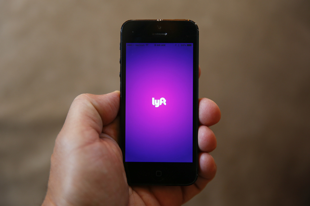A smartphone displays the Lyft app. The ride-sharing company announced that it is offering service to passengers in every corner of 32 U.S. states, including Maine. The move boosts the number of states with full coverage to 40.