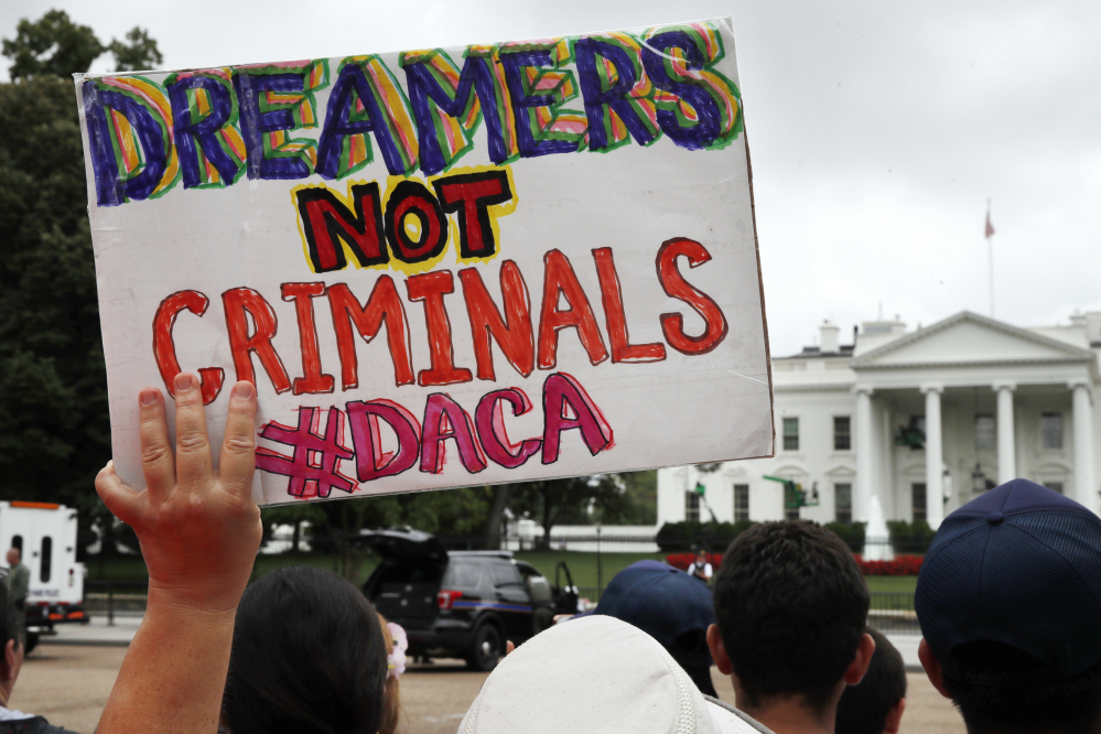 A sign supports the Obama administration program, Deferred Action for Childhood Arrivals, at the White House on Aug. 15.
