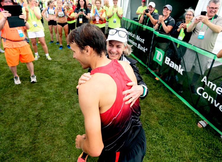 Ben True is greeted by Joan Benoit Samuelson, the race founder, after becoming the first American to win the Beach to Beacon last year. True will race again Saturday.