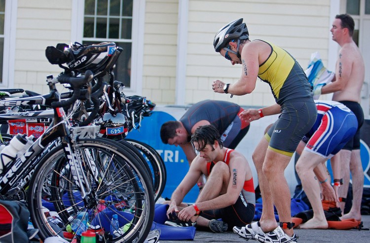 Athletes transition from the swim to the bike portion of the Rev3Triathlon in 2014. This year's race, now called the Ironman 70.3 Maine, is scheduled Sunday and expected to draw more than 2,000 triathletes.