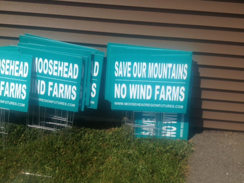 Anti-wind turbine signs are stacked up outside Rockwood Community Center on Wednesday before Somerset County commissioners heard concerns from a group over more turbines that could come to the area.