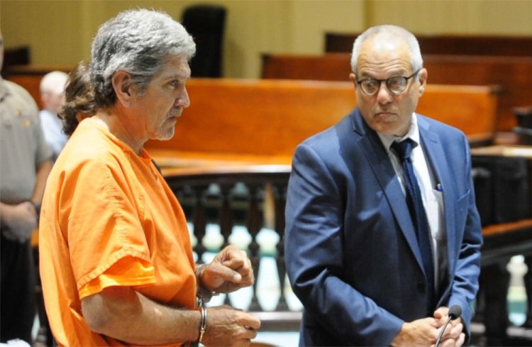 James Sweeney replies through a sign language interpreter to a question from Justice William Stokes as he makes an initial appearance on a murder charge in Androscoggin Superior Court on July 13 in Auburn. His defense attorney, Walter Hanstein, is at right.
