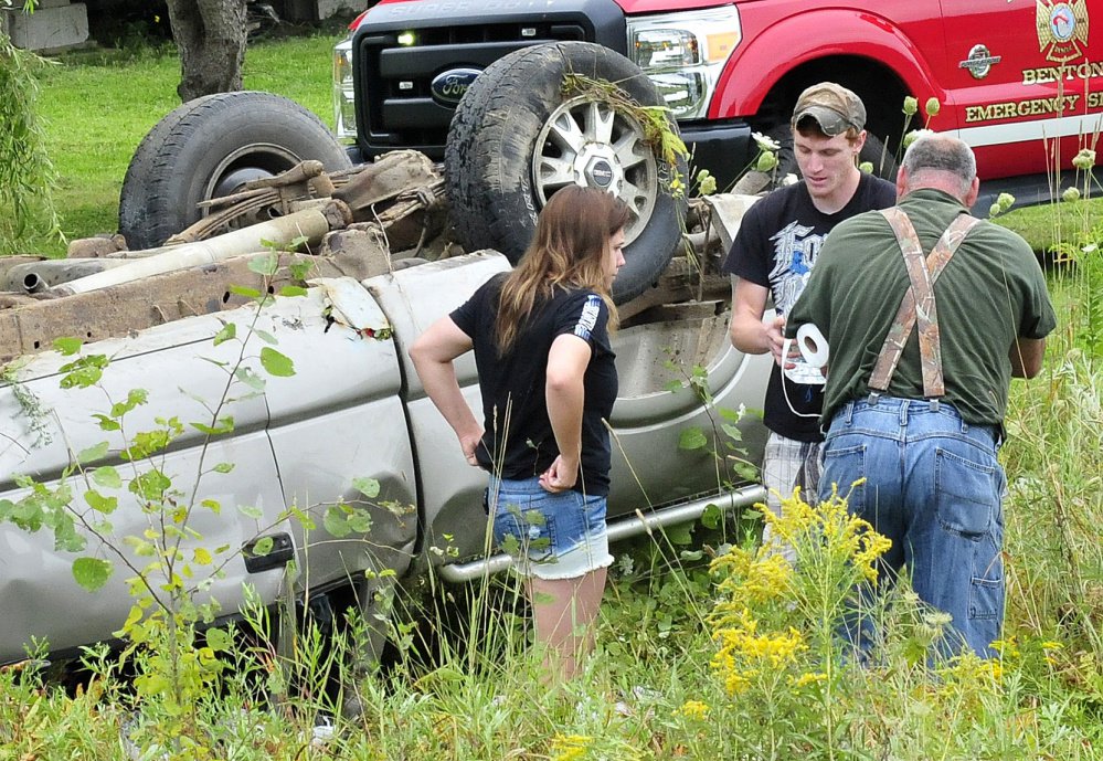Benton homeowners Lisa Jordan and Dylan Ellis, center, and another man were first on the scene of the crash in Benton, which killed a woman.