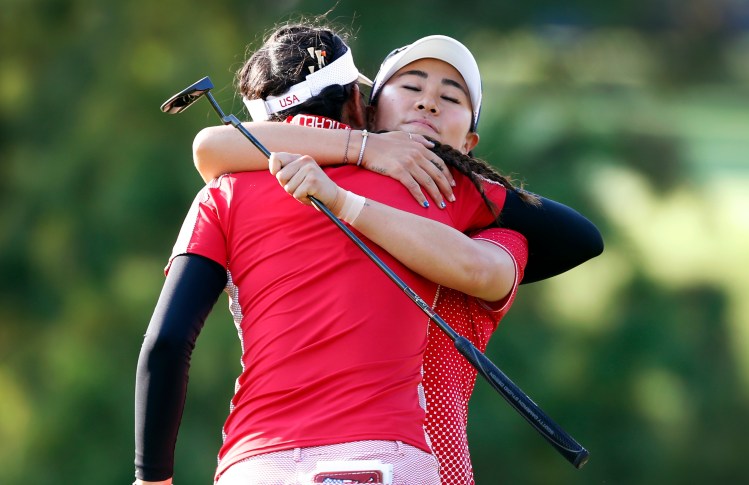 United States' Danielle Kang, right, gets a hug from teammate Michelle Wie after their four-ball match victory in the Solheim Cup golf tournament Friday in West Des Moines, Iowa.