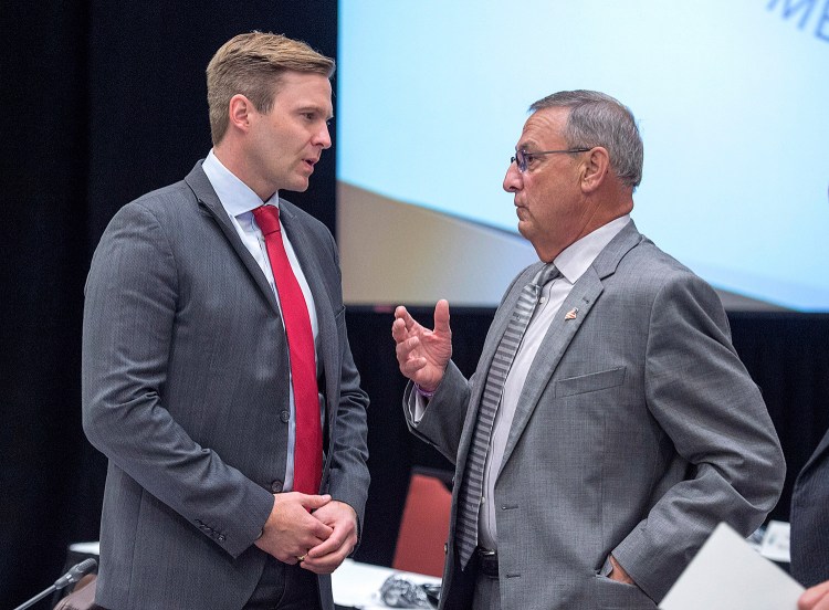 New Brunswick Premier Brian Gallant, left, and  Gov. Paul LePage chat at the start of a meeting of New England governors and Eastern Canadian premiers in Charlottetown, Prince Edward Island.