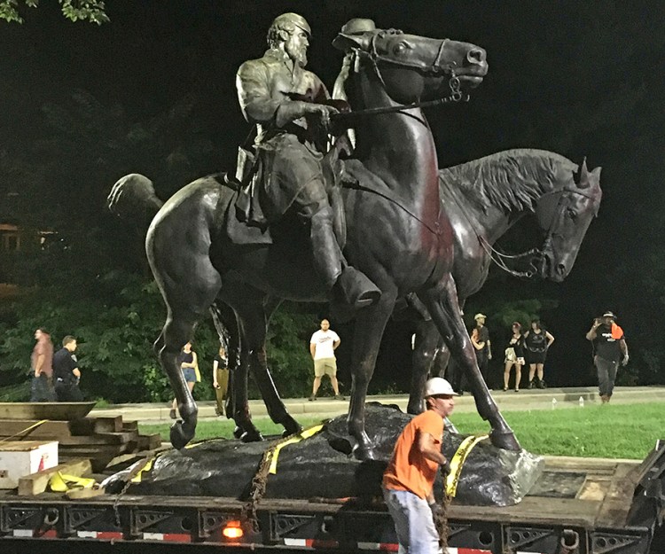 Workers remove the monuments to Robert E. Lee, commander of the pro-slavery Confederate army in the American Civil War, and Thomas "Stonewall" Jackson, a Confederate general, from Wyman Park in Baltimore on Wednesday. 