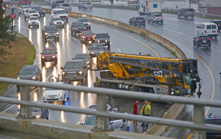 Traffic was slowed in both directions Friday afternoon after a crane crashed in the southbound lane just south of Tukey's Bridge on Interstate 295 in Portland on Friday afternoon.