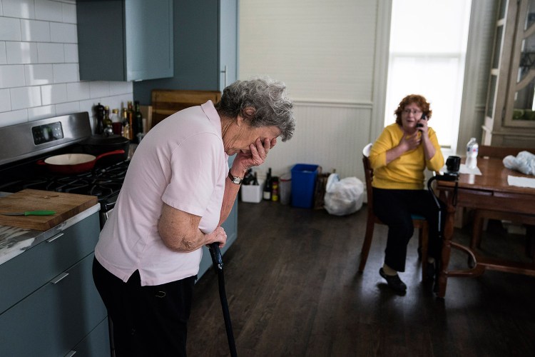 Becky Bain, 58, and her mother Miriam Bain, 82, react as a family member calls to tell them their home survived Hurricane Harvey. They evacuated to a shelter, and are staying in a rental home owned by Anne Whitlock and Michael Skelly in Houston. 