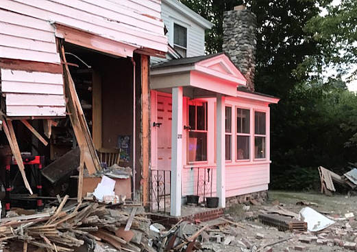Police say the homeowner was not at home when the truck hit his residence on Main Street in Waterboro.