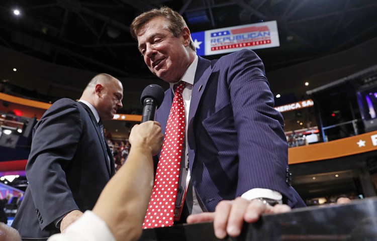 Paul Manafort, then-Republican presidential candidate Donald Trump's campaign manager, talks to the media from the Trump family box on the floor of  the Republican National Convention in Cleveland on July 18, 2016. 