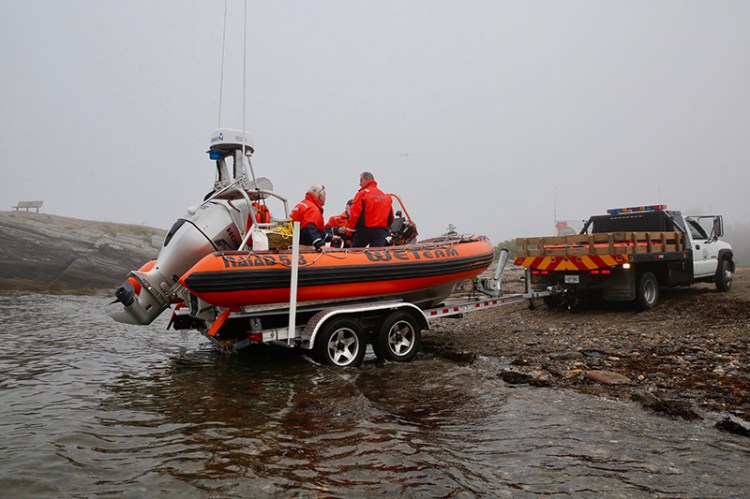 The Cape Elizabeth Water Extraction Team prepares to depart from Kettle Cove in the fog Friday morning.
