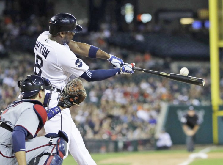 Justin Upton of the Tigers connects for a two-run, walk-off home run in the ninth inning Saturday against the Twins in Detroit. The Tigers blew a 5-0 lead and rallied from an 11-6 hole. 