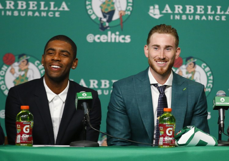 Boston Celtics' Kyrie Irving, left, and Gordon Hayward laugh during a news conference in Boston, Friday, Sept. 1, 2017. (AP Photo/Winslow Townson)