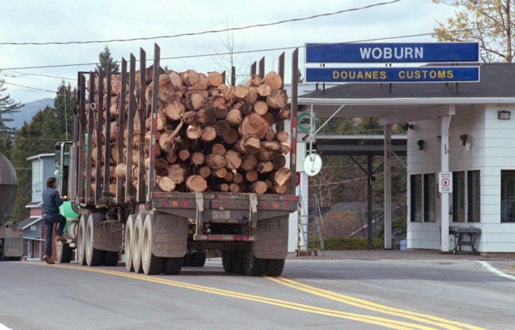 A logging truck enters Woburn, Quebec, from Coburn Gore, Maine. Canadian officials are looking to Gov. LePage to help convince President Trump not to raise new trade barriers that would disrupt commerce.