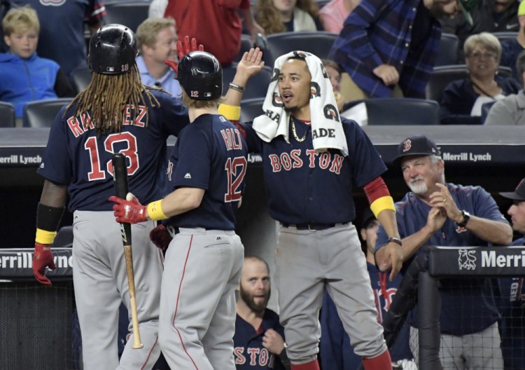 Boston's Hanley Ramirez celebrates with Brock Holt, 12, and Mookie Betts, right, after hitting a home run in the seventh inning Friday night at Yankee Stadium.