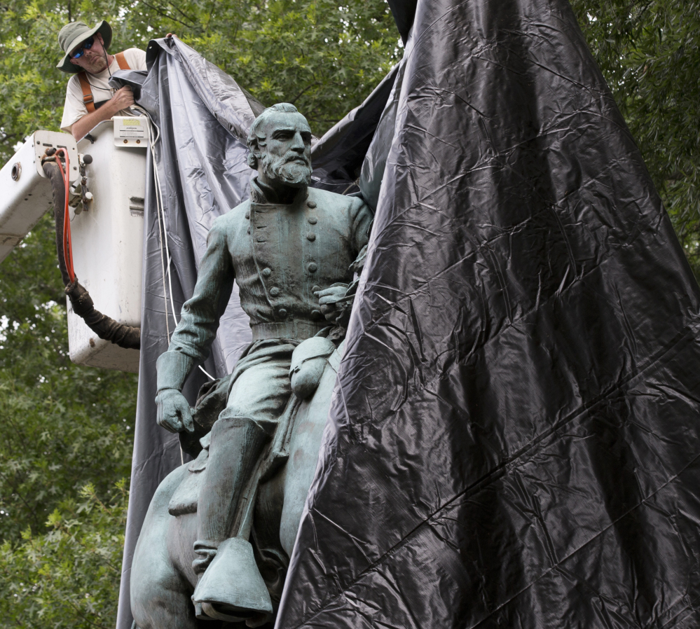 A city worker covers a statue of Confederate general Thomas 'Stonewall' Jackson in Charlottesville, Virginia, last month. It is one of two statues the City Council voted to remove.