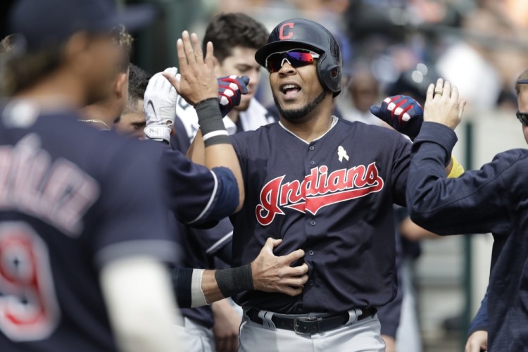 Edwin Encarnacion of the Indians is congratulated after his solo homer in the sixth inning of the first game at Detroit on Friday, a 3-2 Cleveland win. The Indians won the night game 10-0.