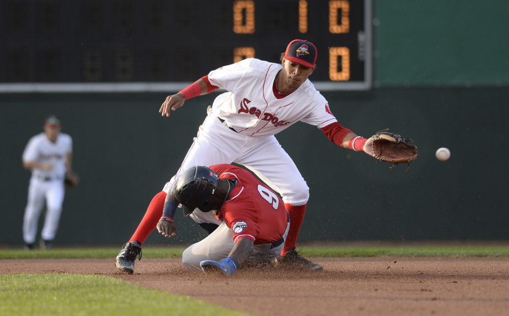 Portland's Deiner Lopez can't reach the ball as J.D. Davis of New Hampshire slides safely into second base with a stolen base during Saturday;s game at Hadlock Field in Portland. The Sea Dogs won, 5-4 in 10 innings.