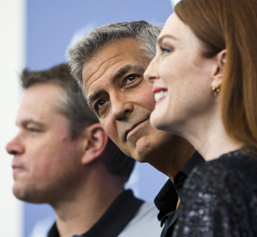 George Clooney, center, poses with Julianne Moore and Matt Damon at the 74th Venice Film Festival in Venice, Italy, on Saturday.