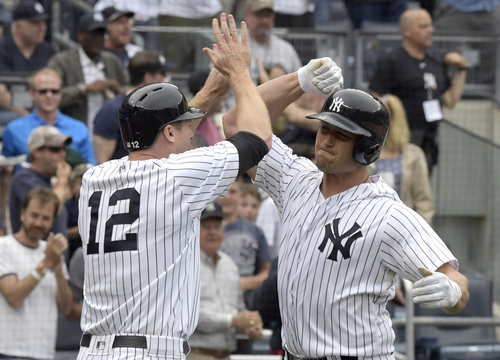 Matt Holliday, right, celebrates with Chase Headley after Holliday's three-run home run in the sixth inning of Saturday's game against the Red Sox at Yankee Stadium in New York.