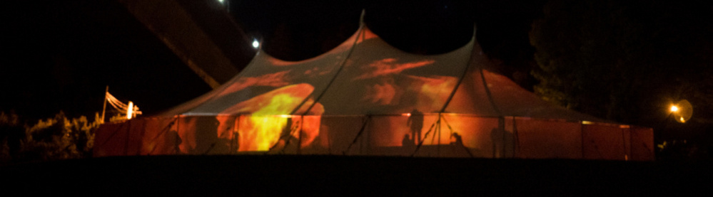 The performance of "no plan b" happens on a broad stage under a big-top tent where images are projected.