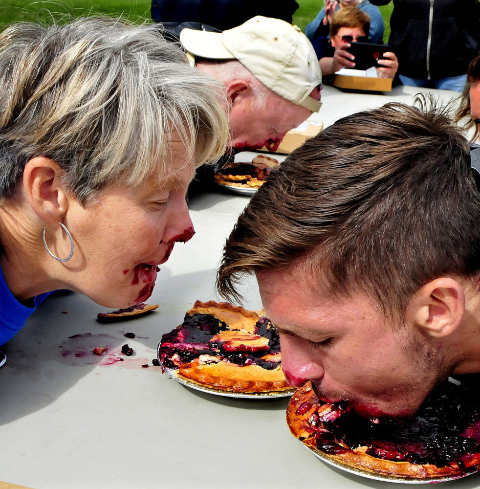 From left, Democratic candidates for governor Betsy Sweet of Hallowell and Patrick Eisenhart of Augusta and U.S. Senate candidate Zak Ringelstein compete in a pie eating contest Sunday.