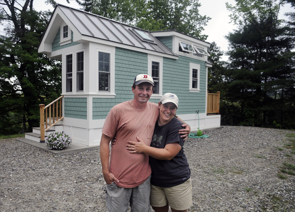 Luke Lucier and Becky Deering stand outside their tiny home in Richmond, where the code enforcement officer has said no more of these homes will be allowed until there are state inspection standards in place.