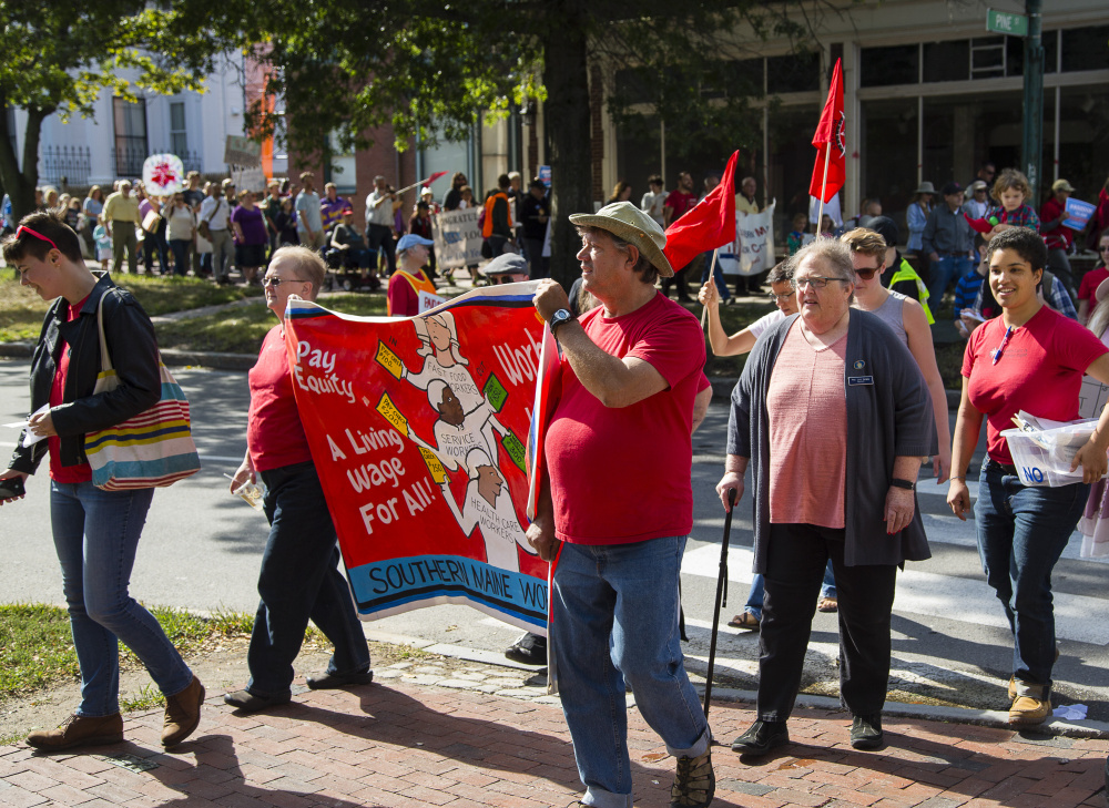Marchers head up State Street to a rally in Portland's Longfellow Square on Monday, to launch a campaign for earned sick days for Portland workers under a proposed city ordinance.