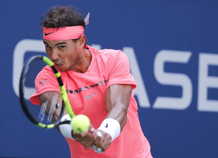 Rafael Nadal returns a shot against Alexandr Dolgopolov during their fourth-round match Monday at the U.S. Open. Nadal, the No. 1 seed, cruised to a 6-2, 6-4, 6-1 victory.
