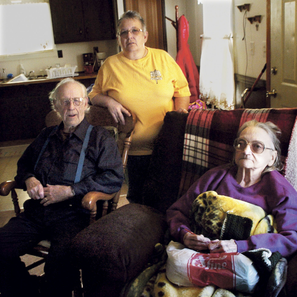 Richard and Leonette Sukeforth, shown seated on Jan. 5, now live in Holden with their daughter Yvette Ingalls, after being evicted from their home in Albion for failing to pay property taxes.