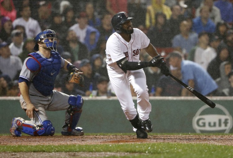 Boston's Jackie Bradley Jr. watches his two-run home run, next to Toronto Blue Jays catcher Miguel Montero, in the fourth inning of Wednesday' game at Fenway Park.