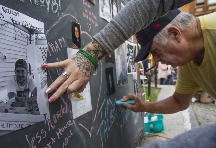 On Aug. 31 – International Overdose Awareness Day – Timothy Talbot Sr. of Portland writes on a Memorial Wall in Monument Square in honor of his son, Timothy Talbot Jr., one of the 185 Mainers who died of drug overdoses in the first six months of this year.